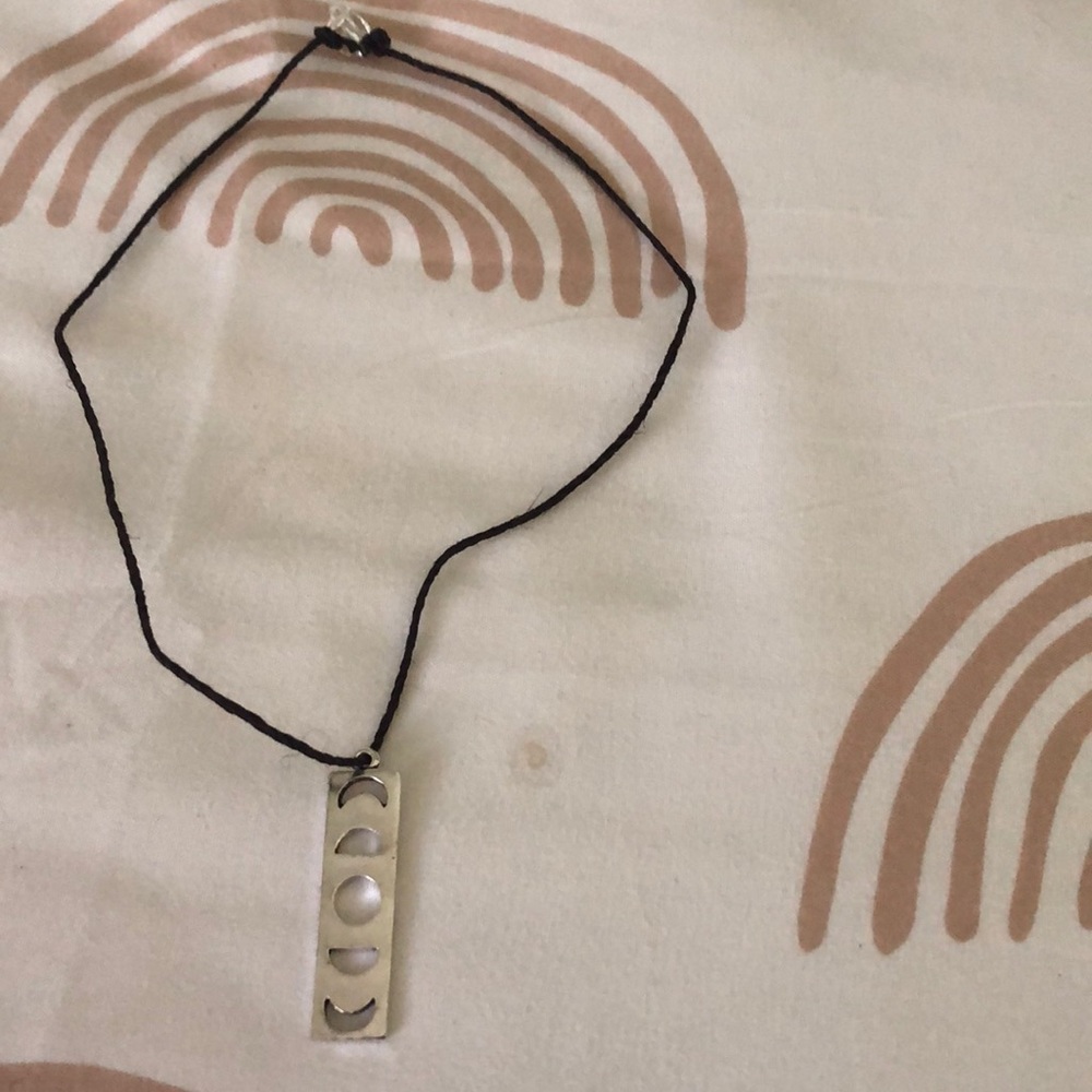 Black necklace with silver moon pendant